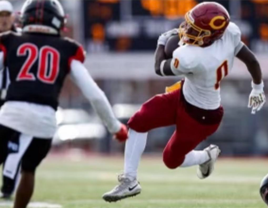 Football player running downfield with the ball